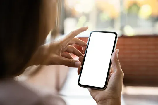 Hand holding smartphone displaying mobile interface