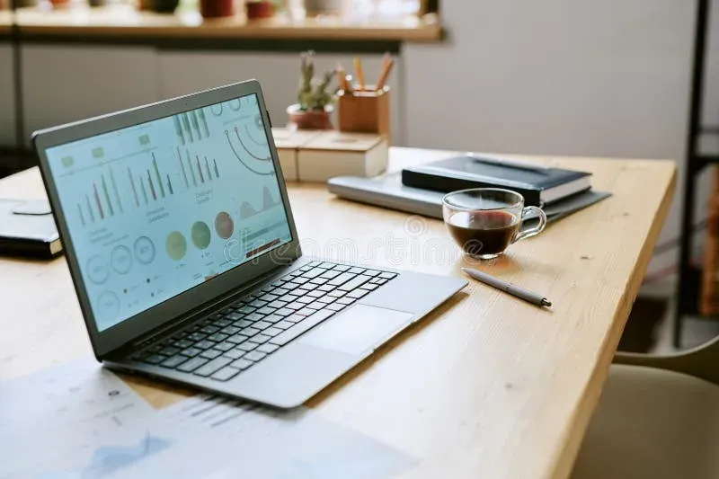 Laptop workspace with analytics dashboard displayed on screen