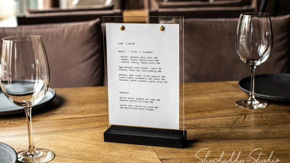 Restaurant menu displayed on table in dining setting with warm lighting