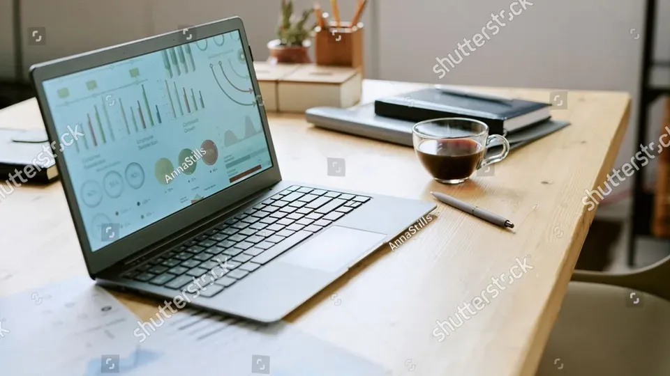 Professional workspace with computer displaying analytics dashboard