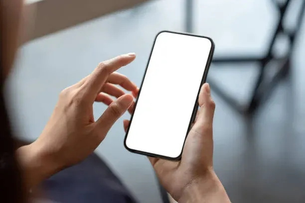 Mobile phone screen in hand showing digital interface or application