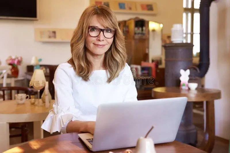 Small business owner working on laptop in a casual workspace