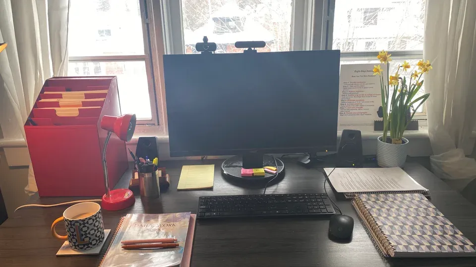 Hands typing on keyboard at workspace during content optimization and editing task