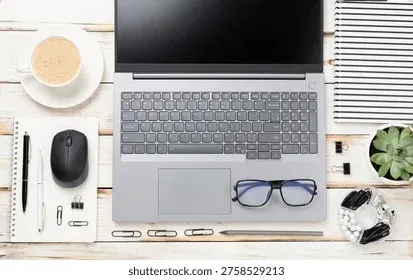 Workspace with laptop and notebook on desk
