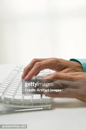 Hands typing on keyboard while creating content