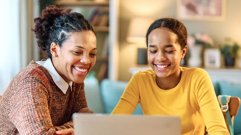 Adult and child learning together at computer