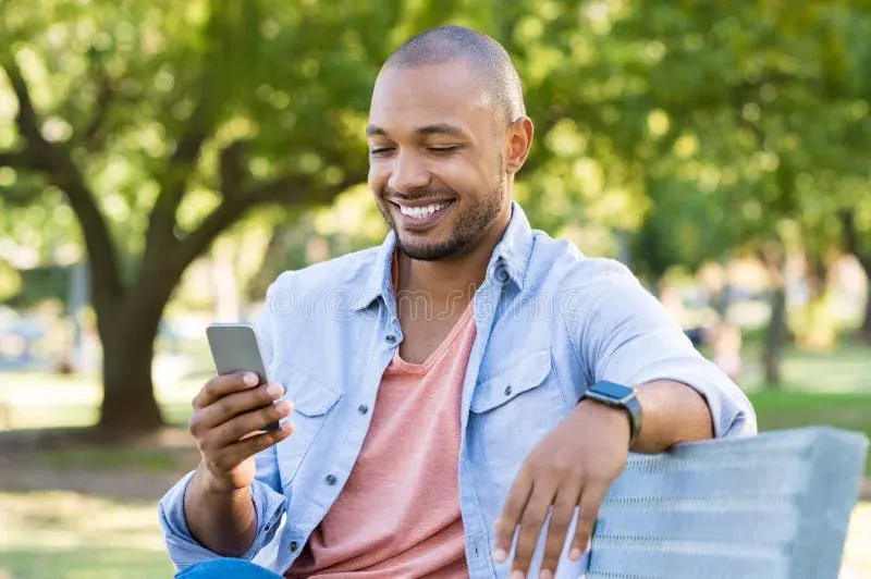 Man reading smartphone with focused expression
