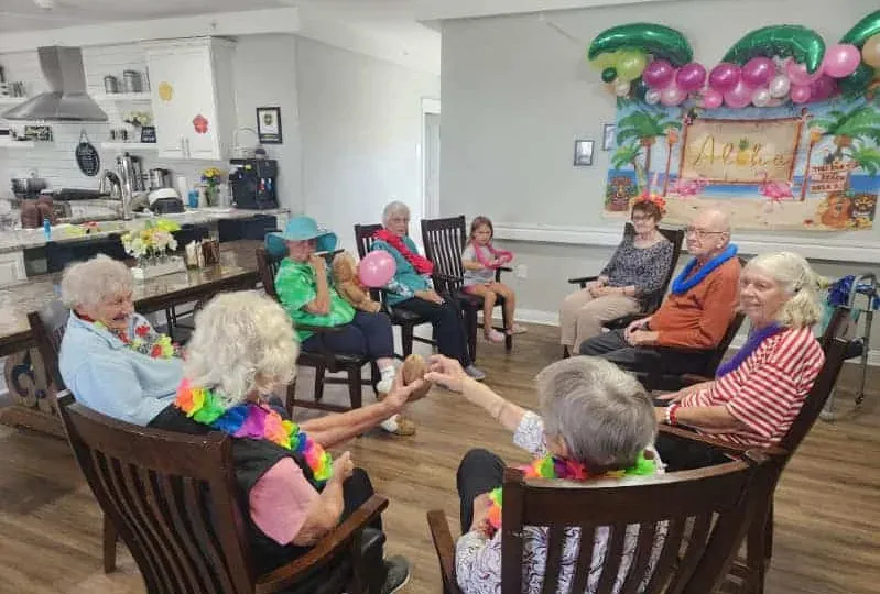 Seniors enjoying activities in a bright, modern senior living community common area