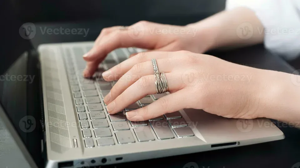 Hands typing on keyboard during focused work session