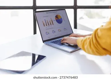 Woman analyzing data and charts on laptop screen
