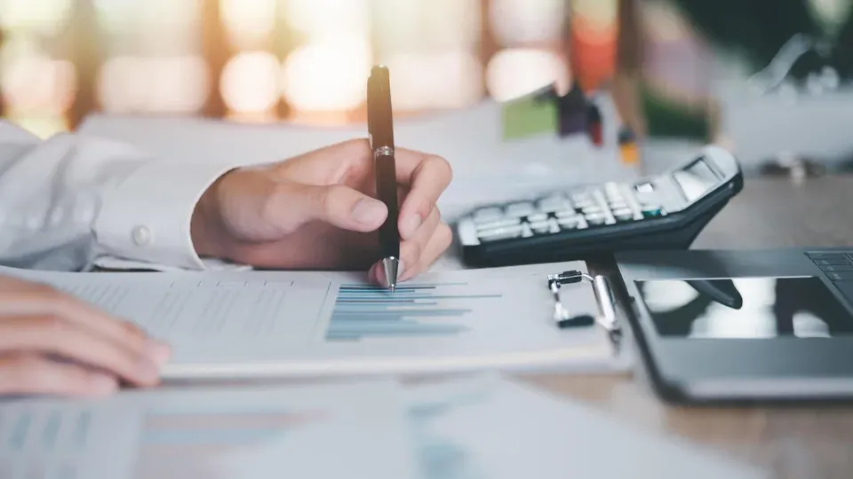 Person reviewing analytics report and performance data at desk