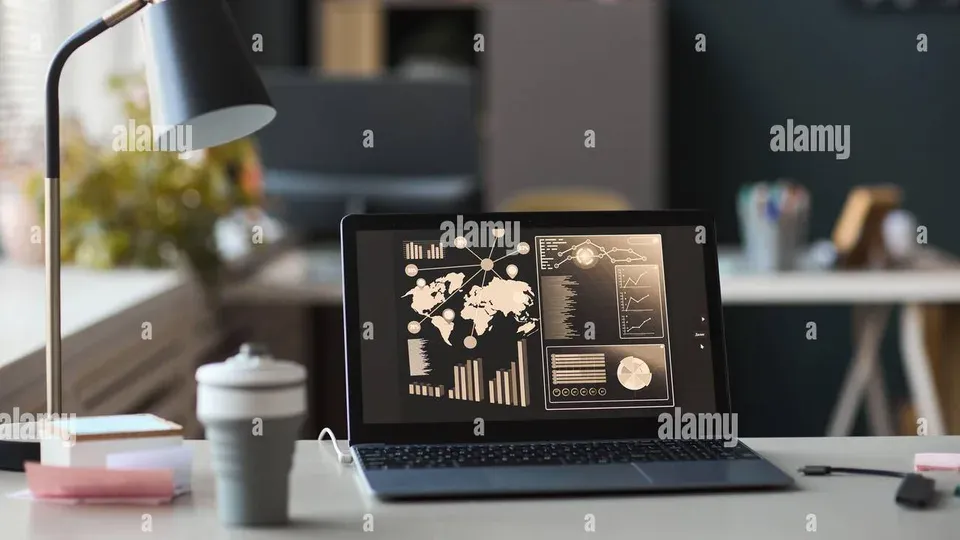Professional workspace with laptop showing analytics dashboard and notebook on desk