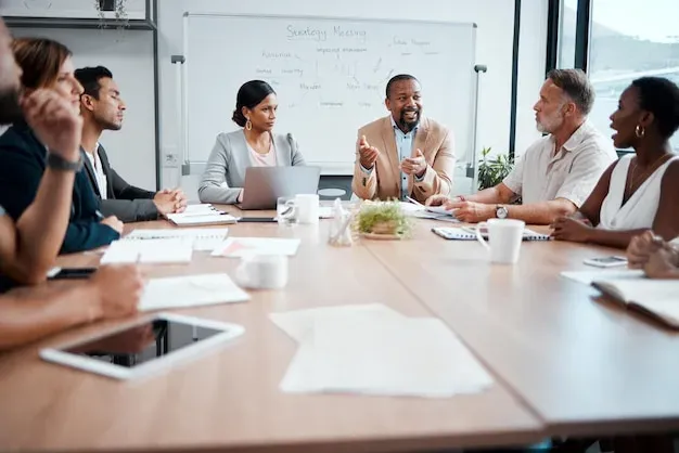 Business team collaborating around table during strategy discussion meeting