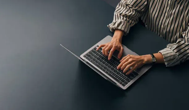 Hands typing on keyboard during focused work session