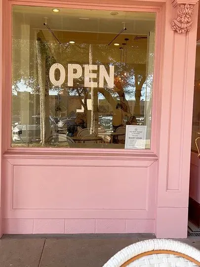 Bakery storefront window displaying fresh croissants and pastries