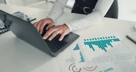 Hands typing on keyboard at desk representing SEO work and optimization
