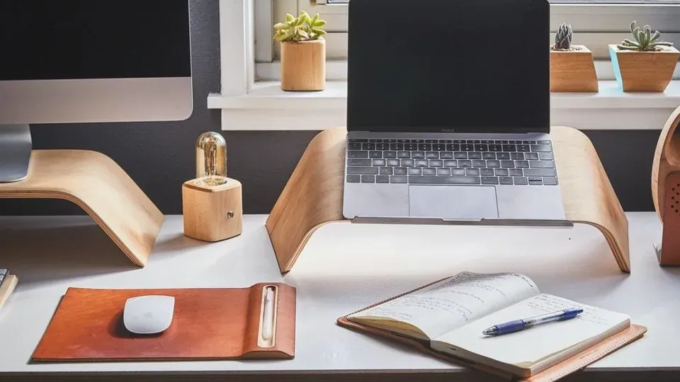 Professional workspace with laptop and writing materials on a clean desk